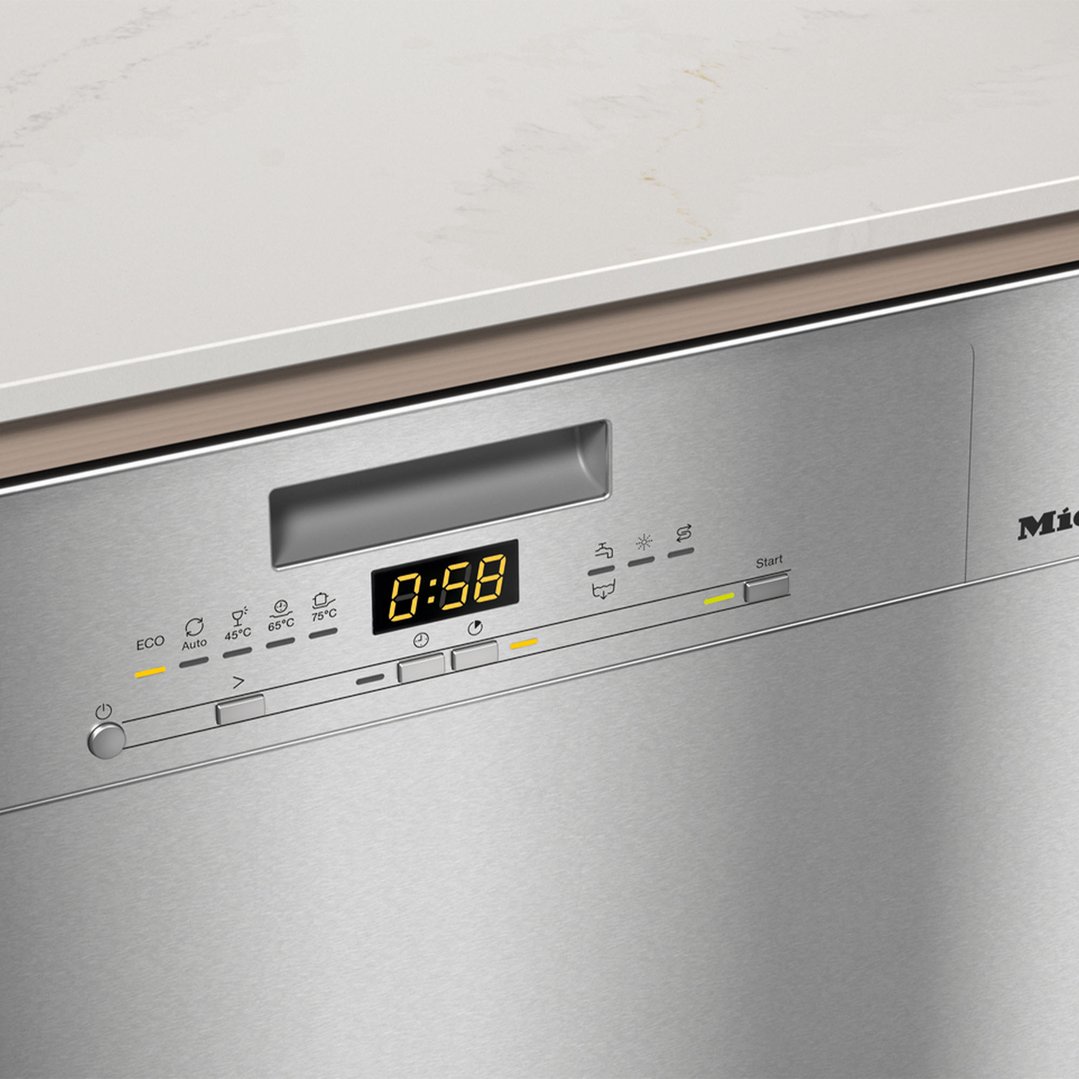 Close-up of a Miele dishwasher control panel with a digital timer showing 0:58