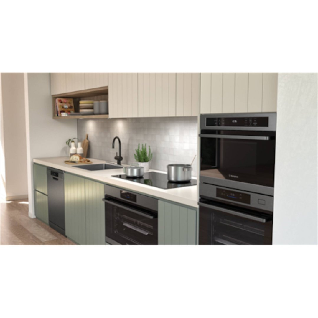 A modern kitchen with a built-in induction cooktop and two ovens