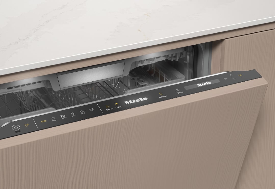 Miele dishwasher with control panel visible, integrated into a light wood kitchen
