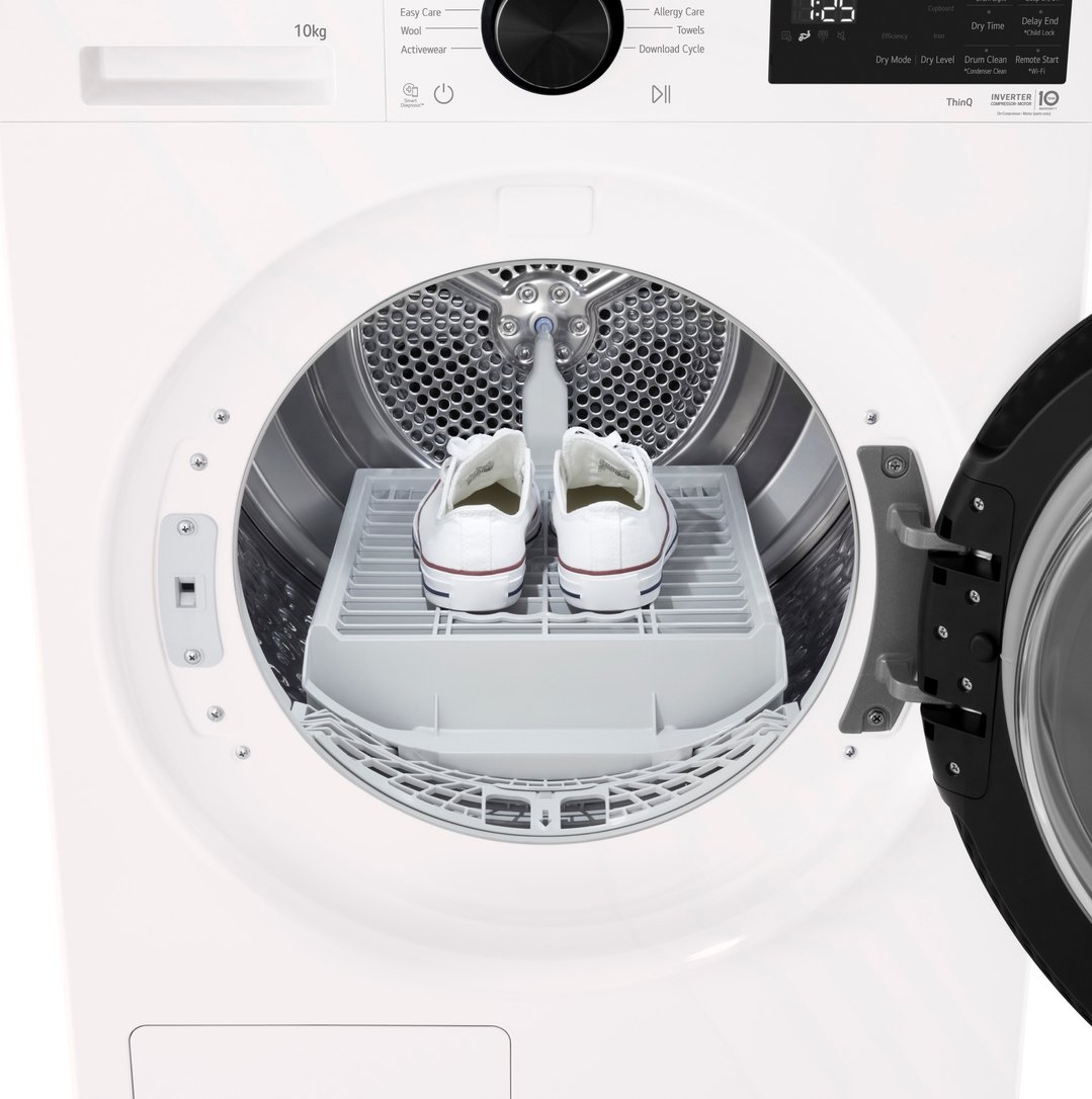 White LG dryer with door open, showing two white sneakers on a drying rack