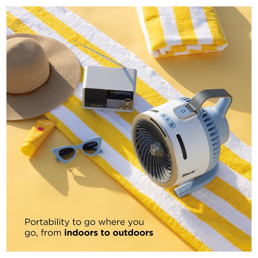 Shark FlexBreeze HydroGo misting portable fan on a striped towel with beach accessories