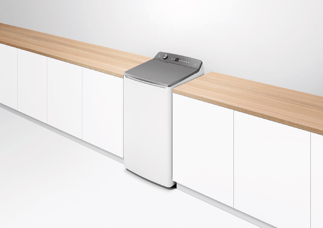 White top loader washing machine in a modern laundry with wooden countertops