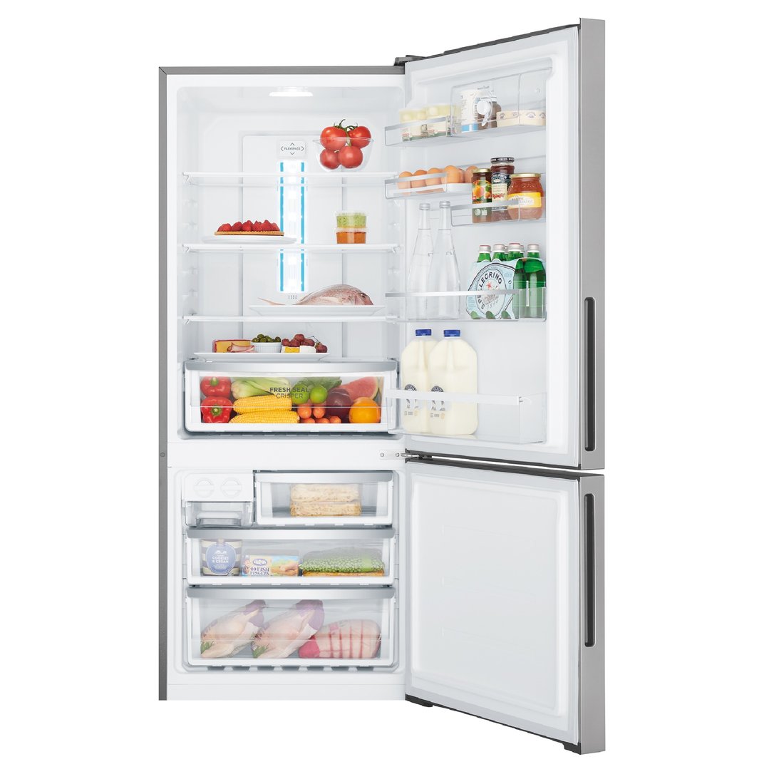 Open bottom mount fridge with food items on shelves and in drawers