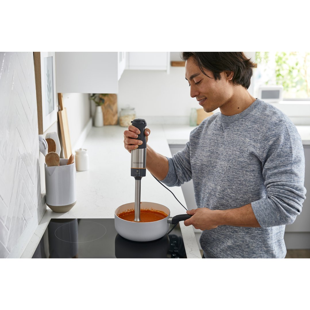 Man using a Kenwood Triblade XL+ Hand Blender to blend soup in a pot