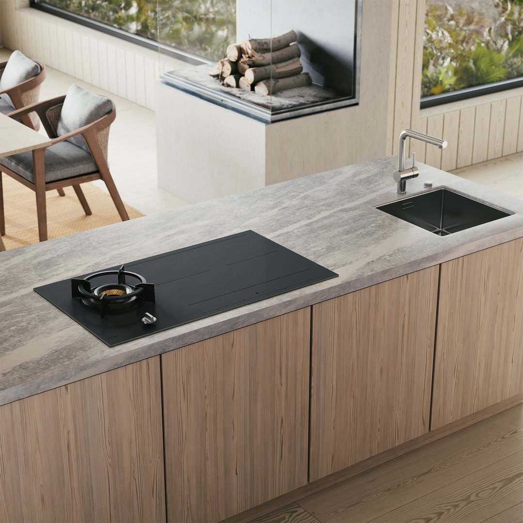 Combined gas and induction cooktop in a modern kitchen with wooden cabinets