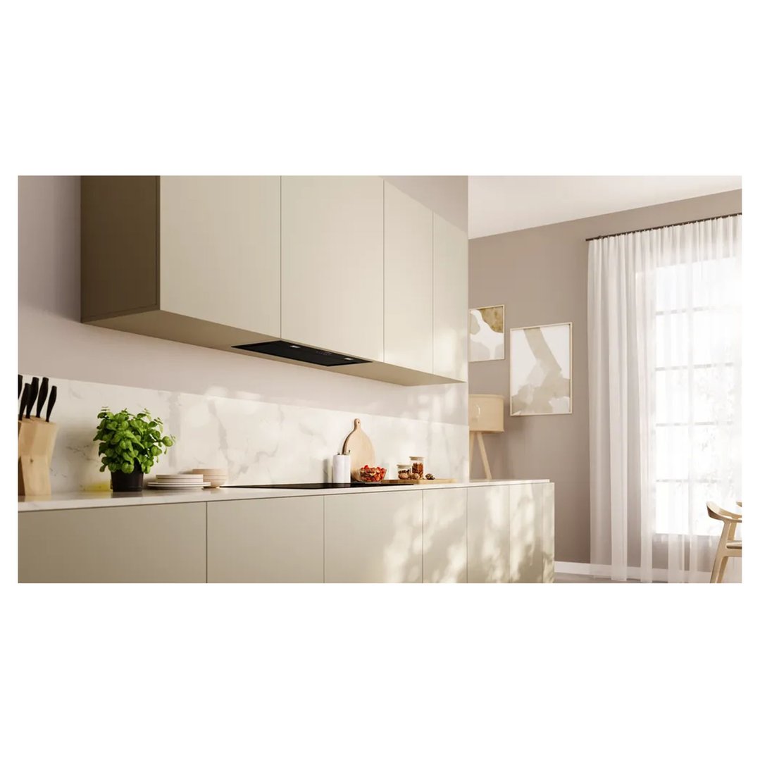 Integrated rangehood in a modern kitchen with light cabinetry and marble backsplash