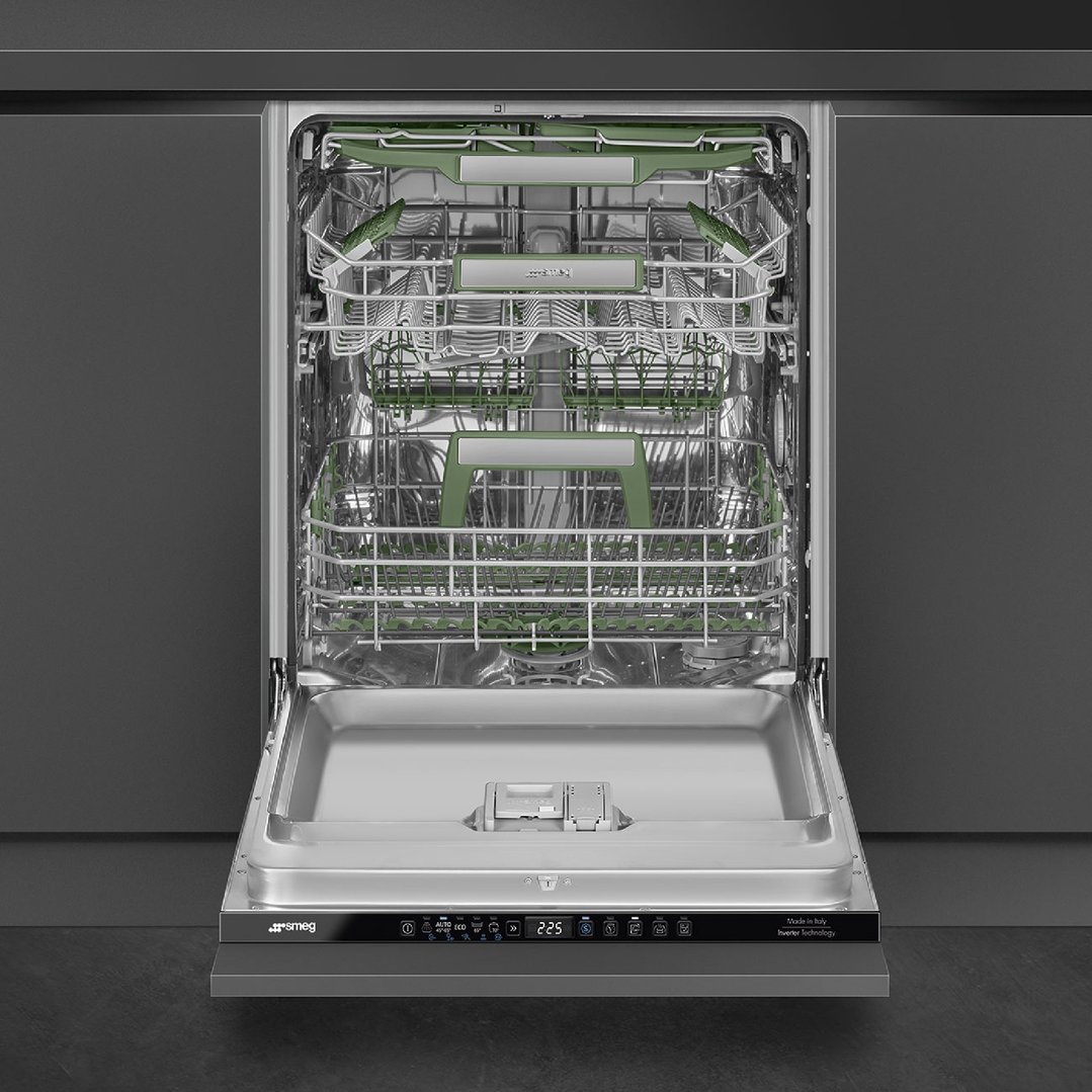 Open Smeg dishwasher with green racks in a dark grey kitchen setting