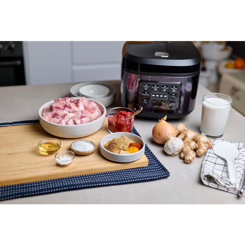 Panasonic 10-cup Rice Cooker on a kitchen counter with ingredients for cooking