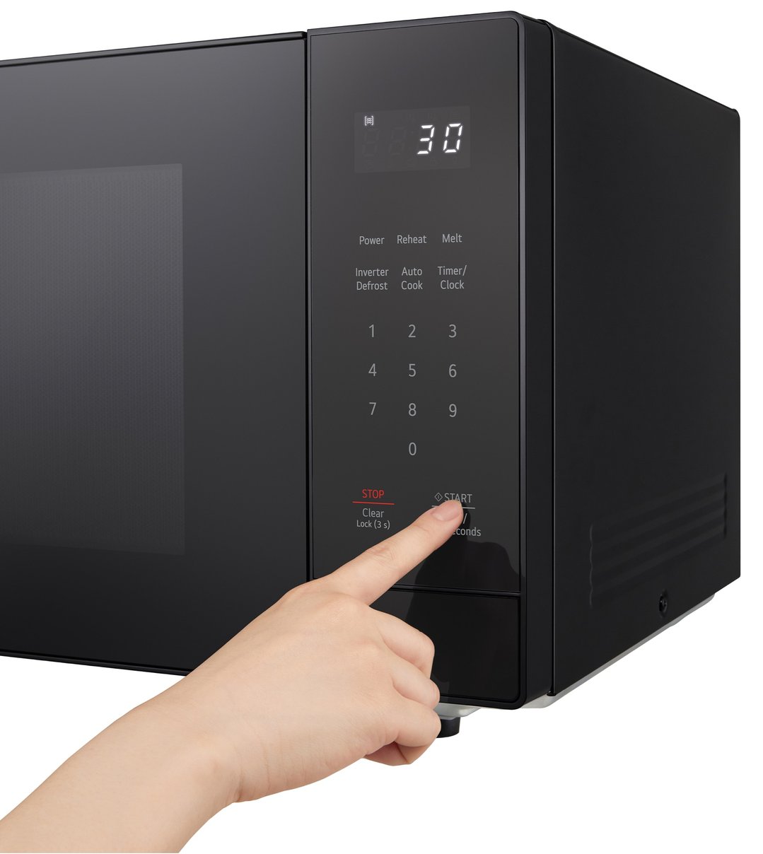 Hand pressing the start button on a black LG microwave control panel
