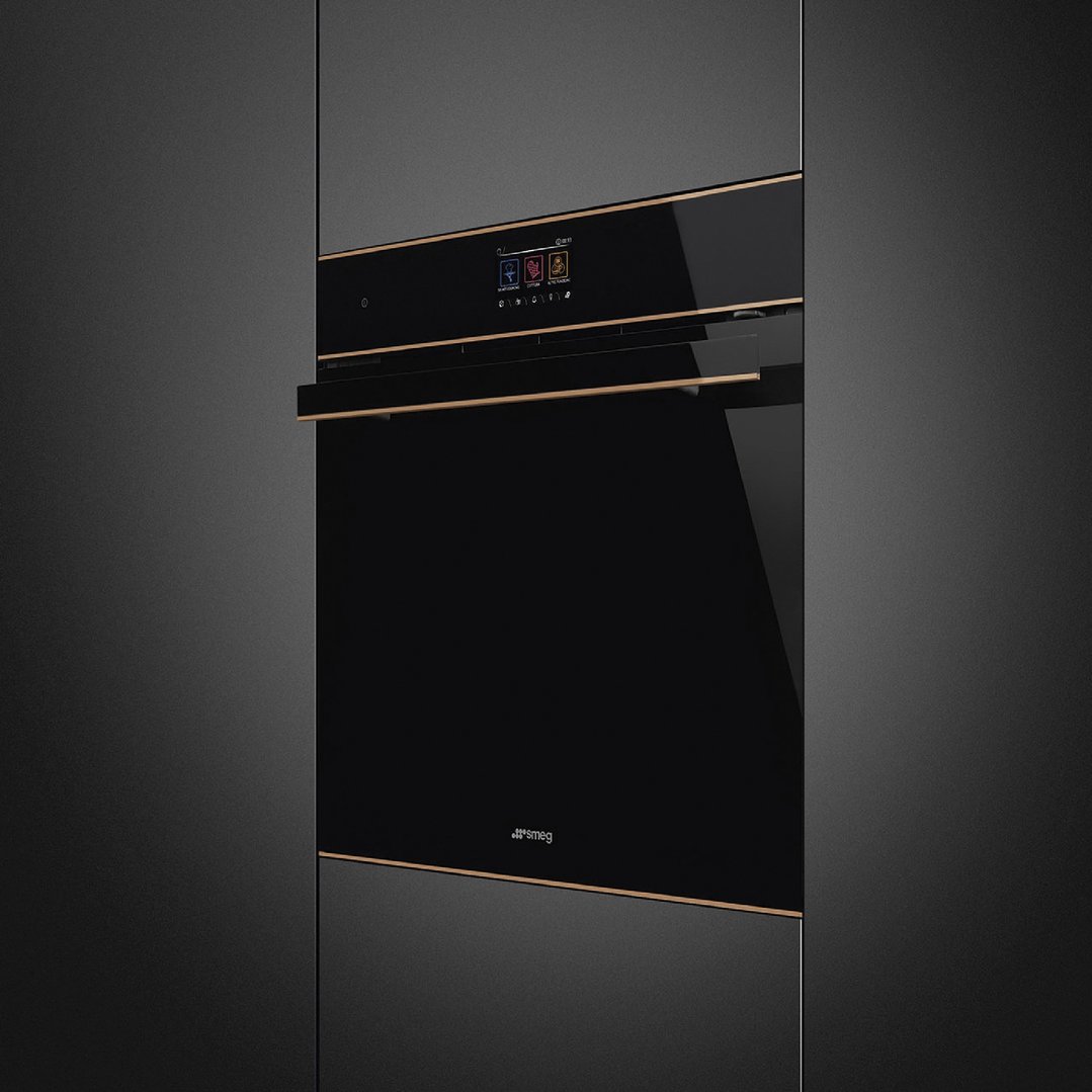 Black and copper trim oven built into a dark kitchen cabinet