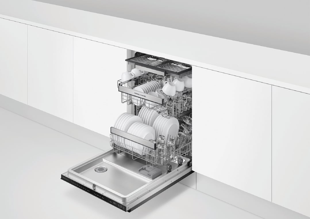 Open built-under dishwasher with clean dishes in a white kitchen