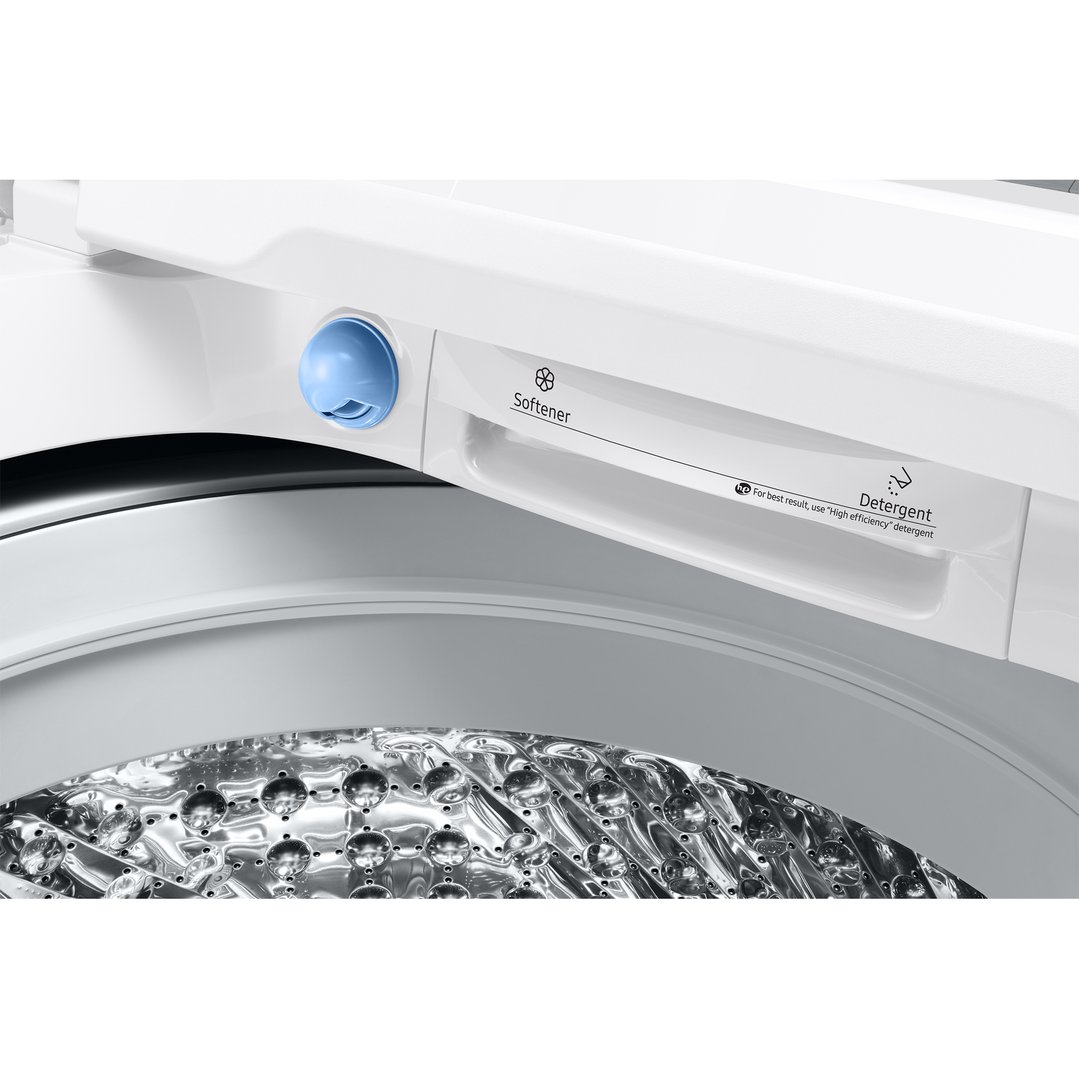 Close-up of a washing machine's detergent and softener dispenser and drum