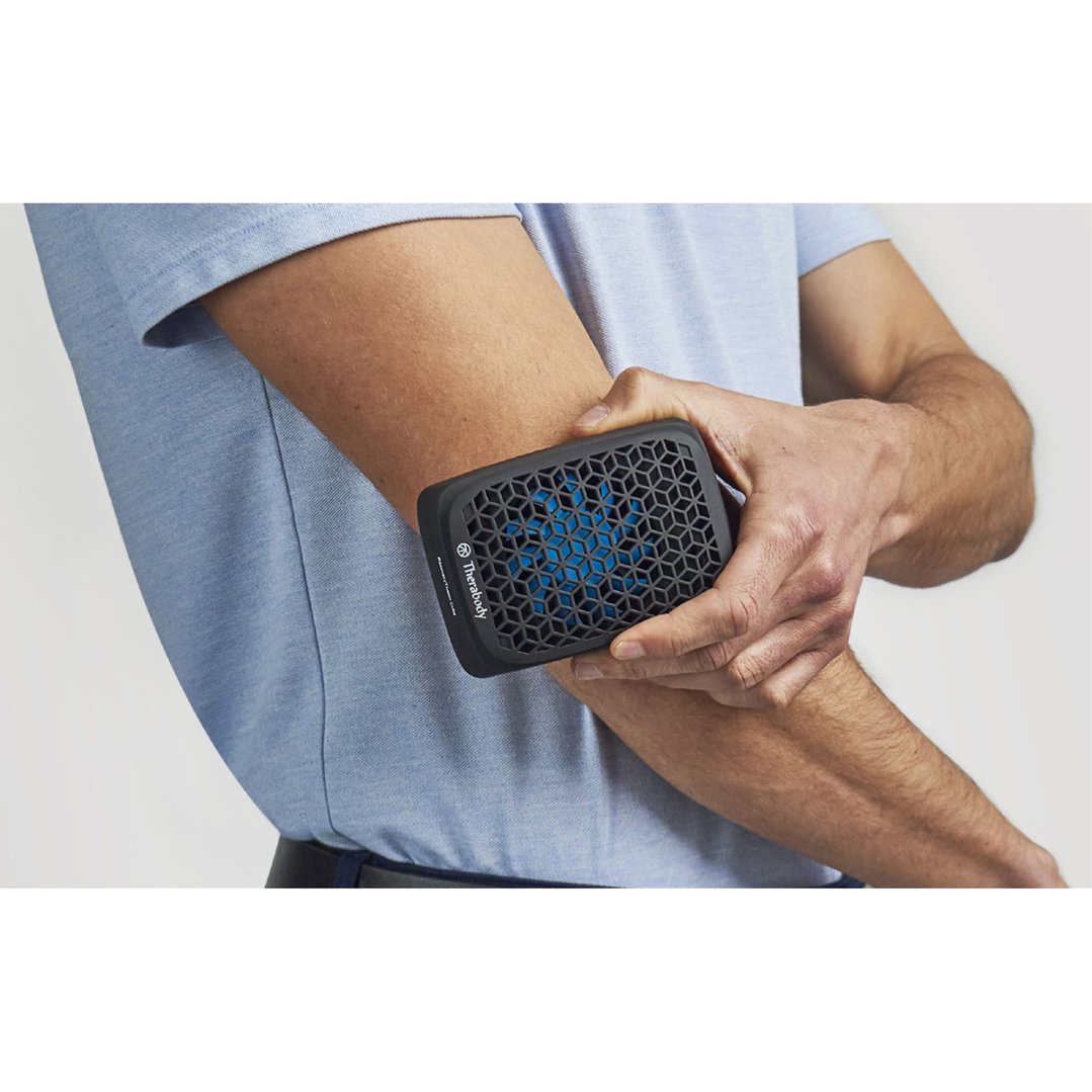 Man holding a black massager against his arm