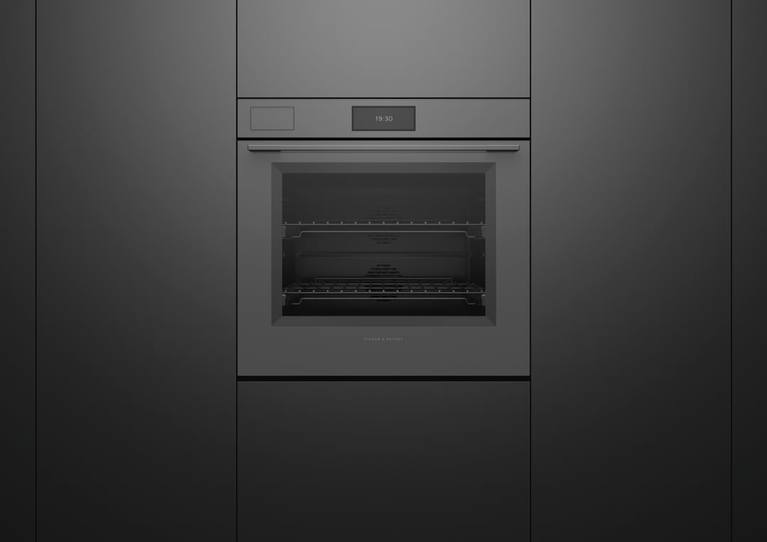 A built-in grey glass oven with a digital display in a dark kitchen