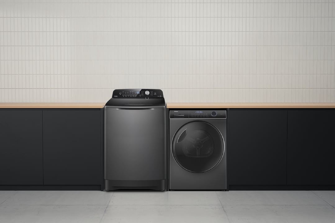 Haier top loader washing machine and dryer in a modern laundry room