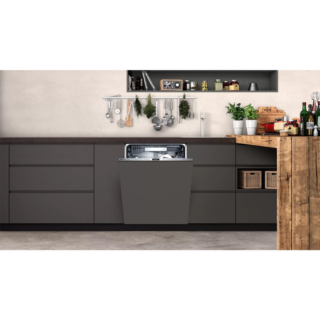 Fully integrated dishwasher with an open door in a modern kitchen setting