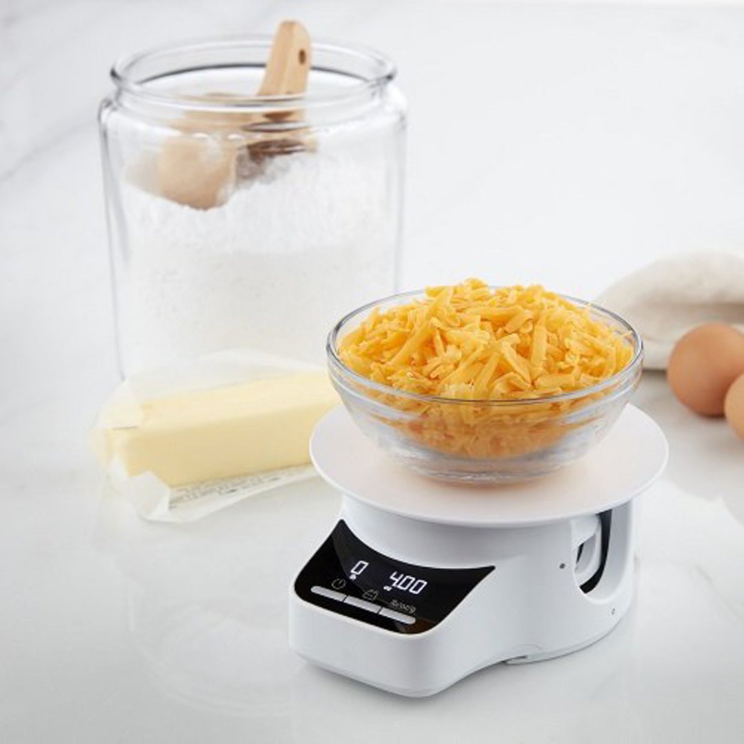 Sifter+Scale Attachment with shredded cheese on a kitchen counter with ingredients