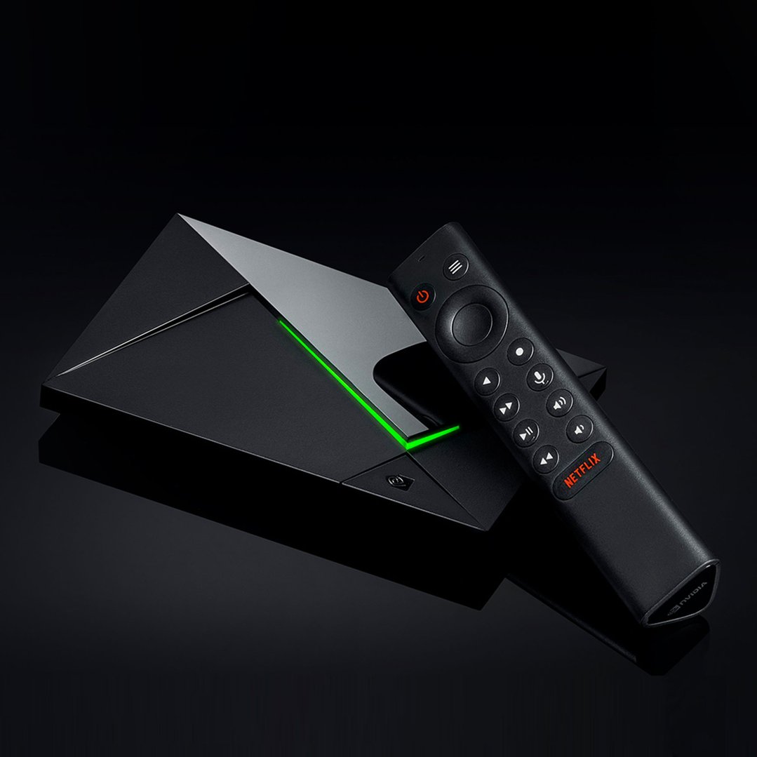 NVIDIA SHIELD TV Pro streaming media player and remote on a dark surface