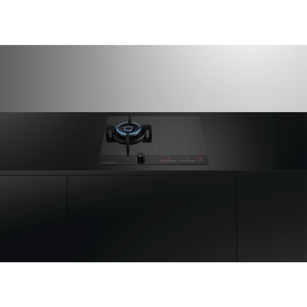 Hybrid cooktop with gas burner and electric zones in a modern black kitchen