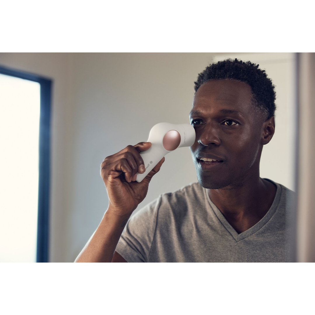 Man using a TheraFace PRO Hot & Cold Rings device on his face