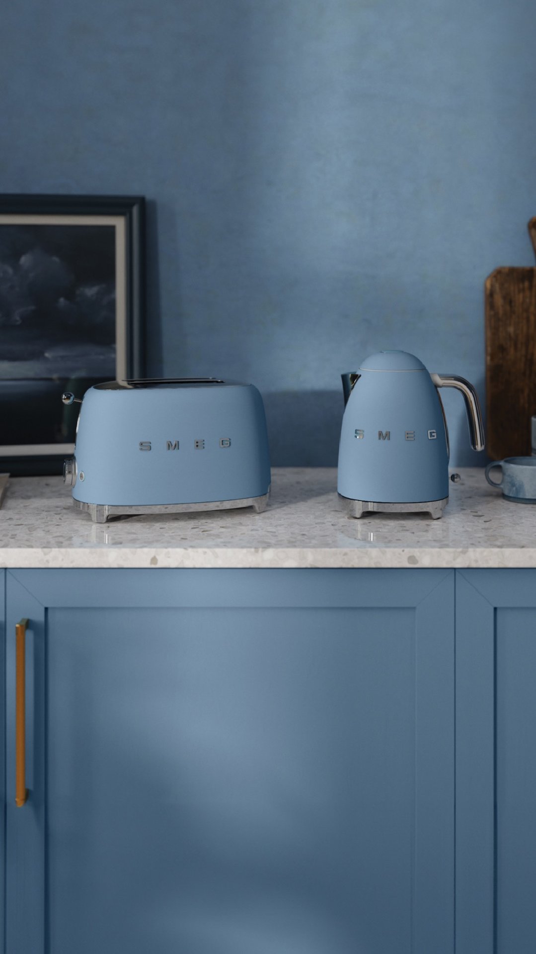Storm blue toaster and kettle on a kitchen counter with blue cabinets