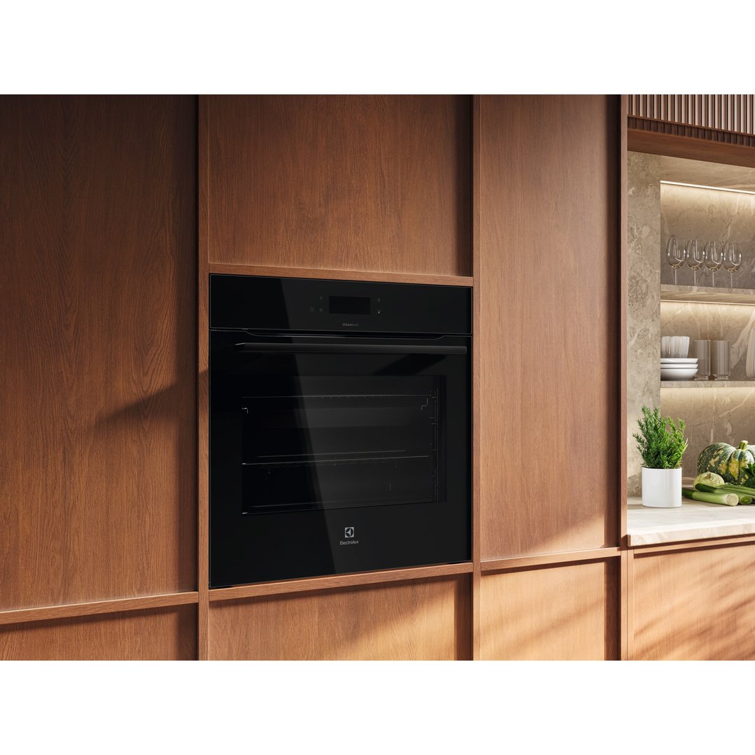 Black built-in Electrolux oven in a modern kitchen with wooden cabinetry
