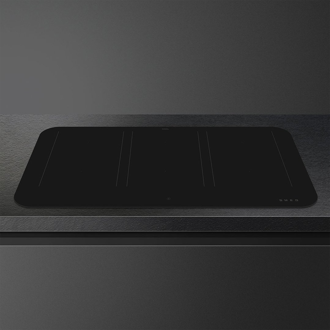 Black induction cooktop built into a dark countertop