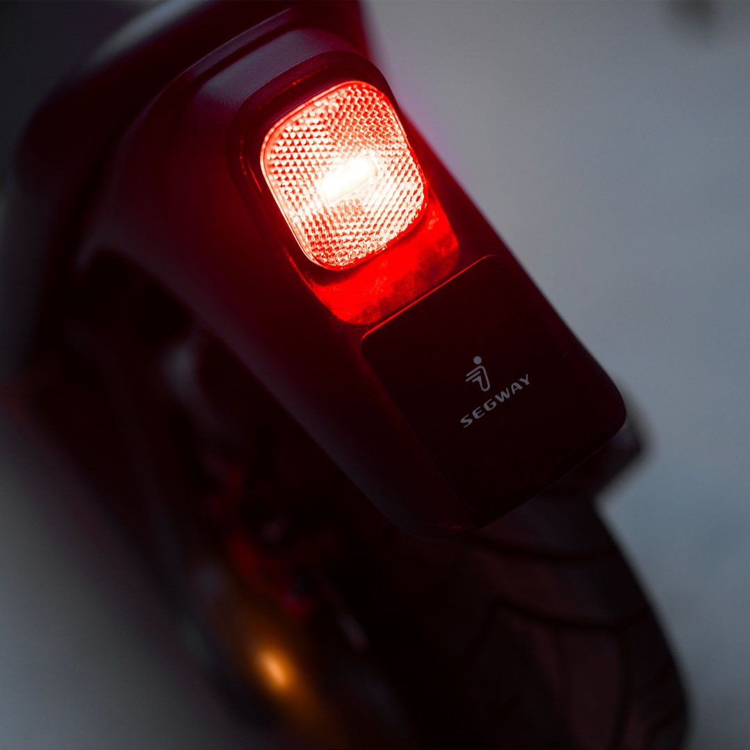 Close up of the red rear light and Segway logo on an electric scooter