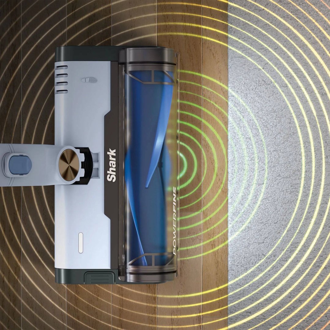 Shark handstick vacuum cleaning a wooden floor and carpet with powerfins visible