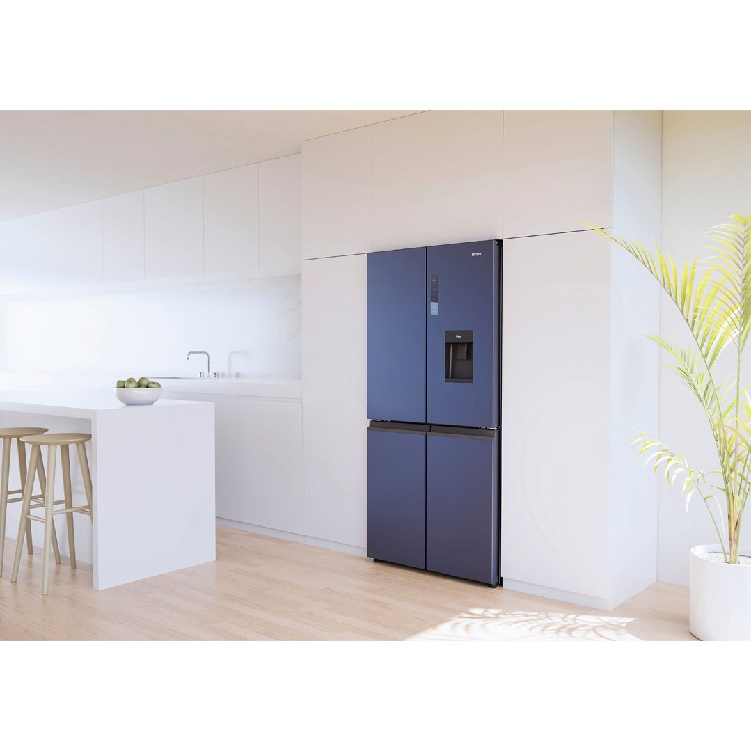 Blue Haier quad door refrigerator freezer in a modern white kitchen