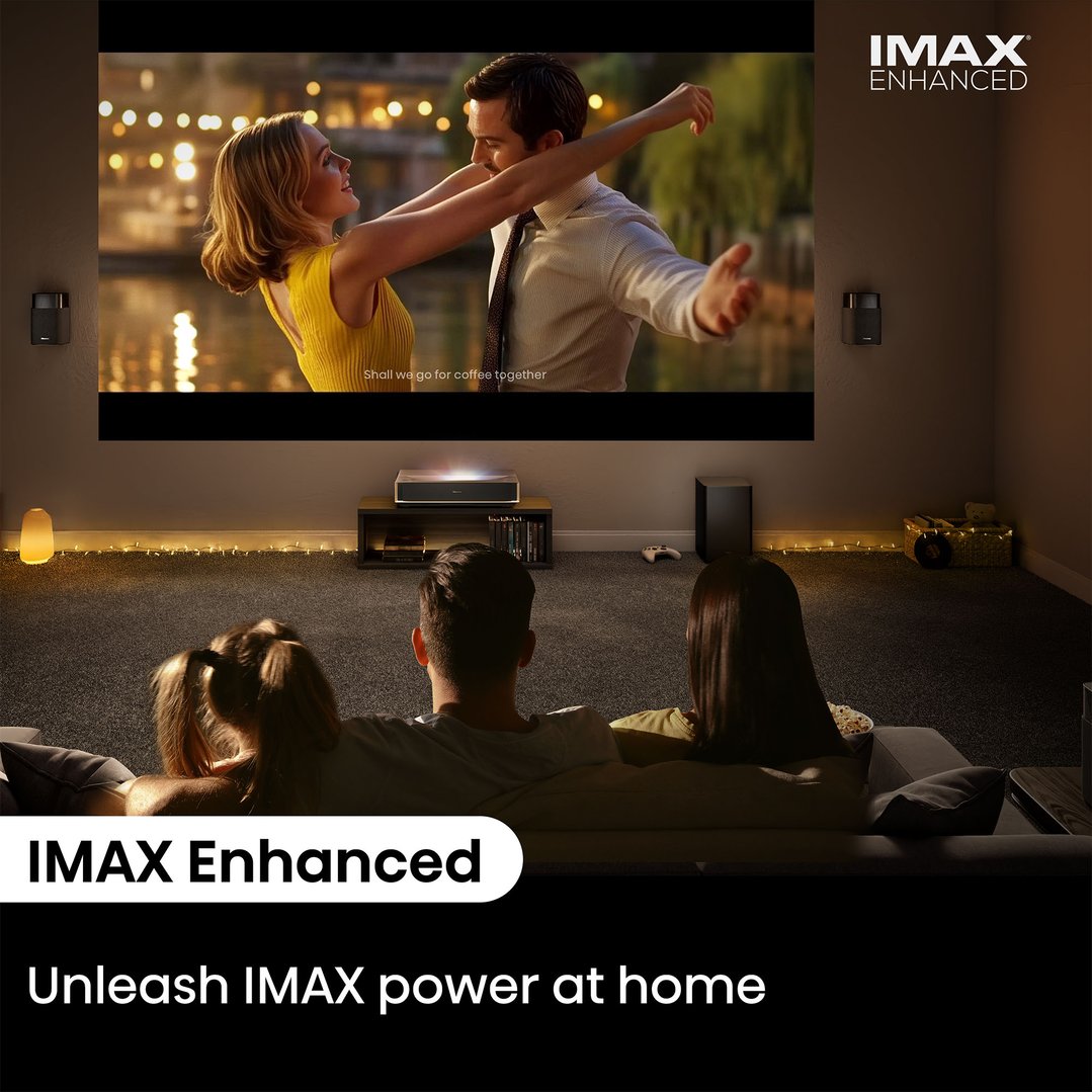 Family watching a movie on a projector in a dimly lit living room
