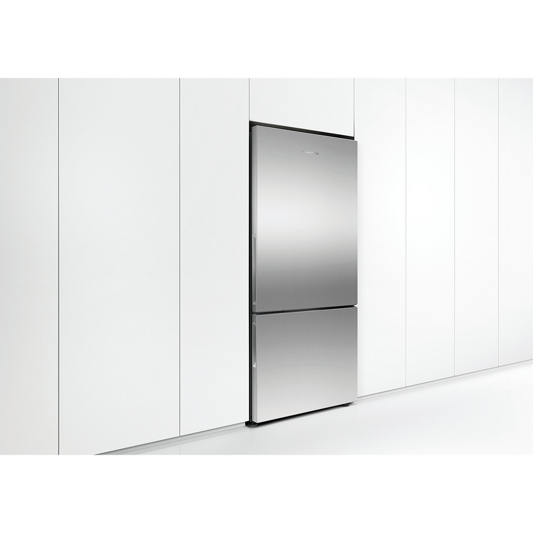 Stainless steel refrigerator freezer integrated into white kitchen cabinetry