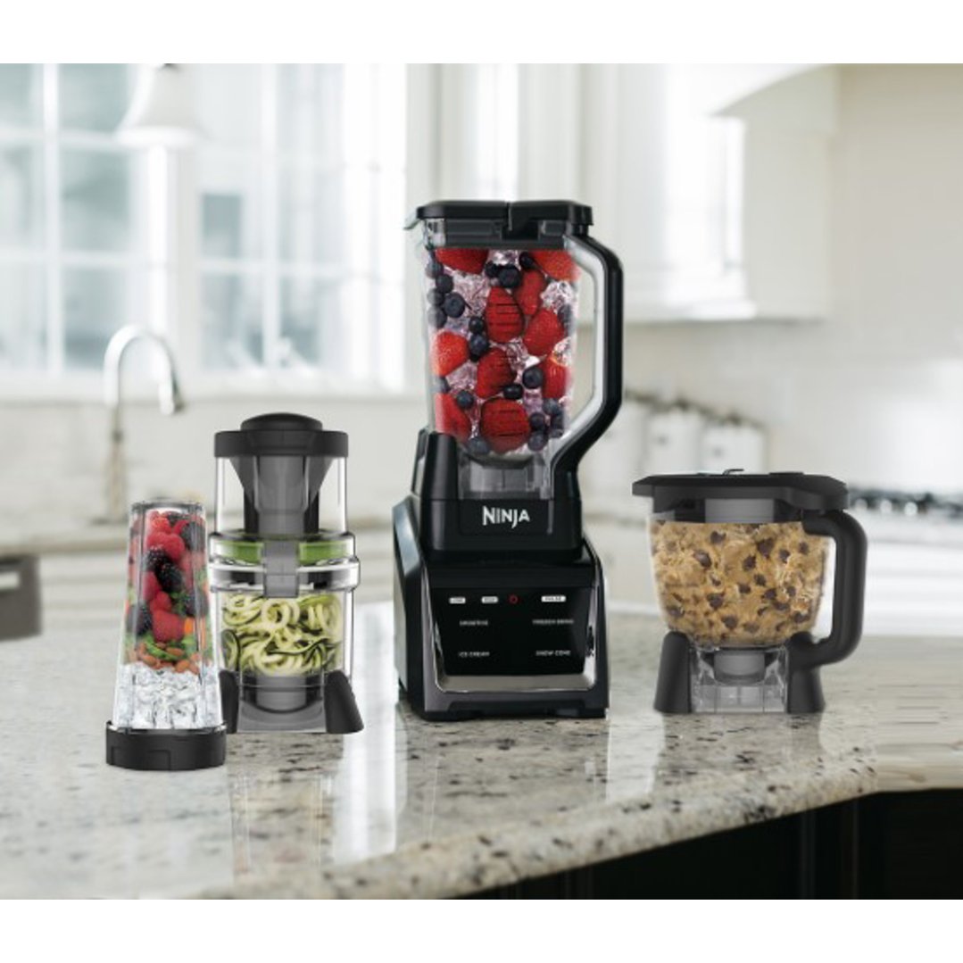 Ninja blenders with various attachments on a kitchen counter