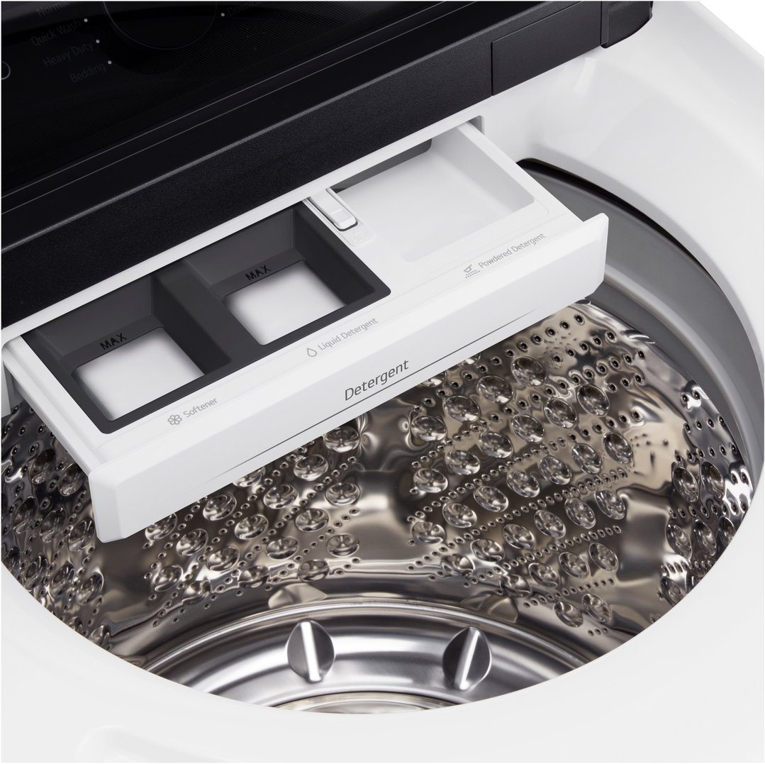 Close-up of the open detergent dispenser drawer of a washing machine