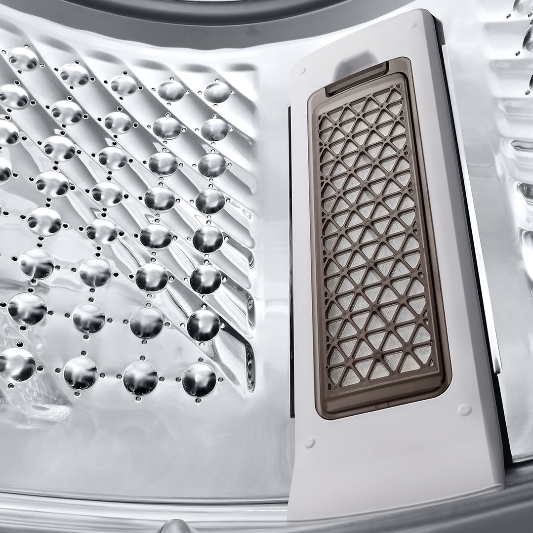 Close-up of the washing machine drum and lint filter