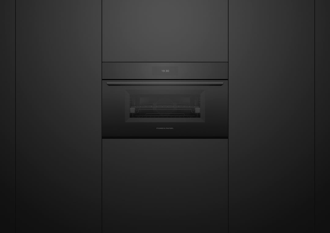A black built-in compact combi-steam oven with a digital display showing 19:30
