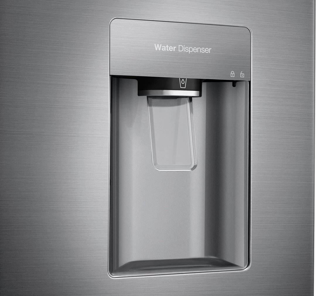 Close up of the water dispenser on a stainless steel fridge