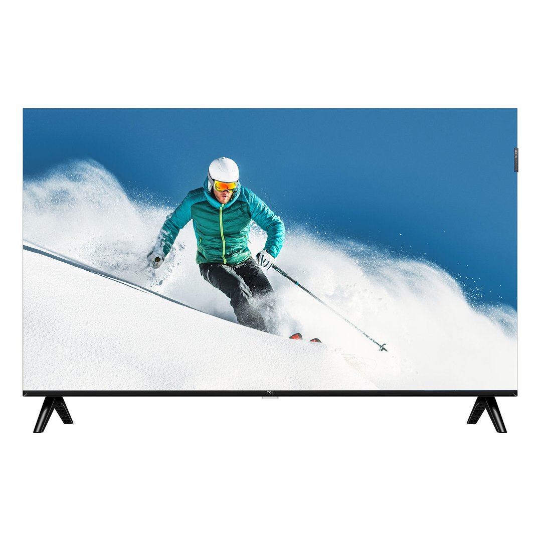 TCL TV on a stand displaying a skier on a snowy mountain