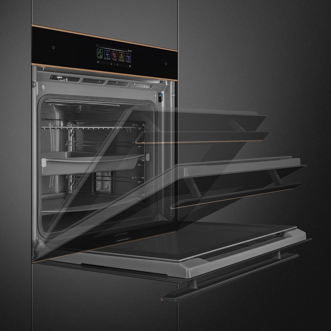 A black Smeg oven with copper trim, door open, showing interior racks