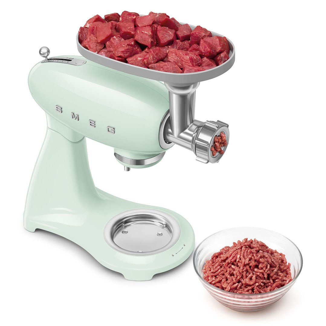 Pastel green stand mixer with meat grinder attachment, processing meat