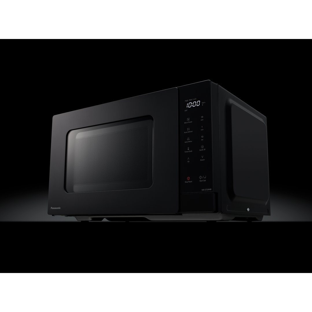 Black microwave oven with digital display showing 10:00, angled on a dark surface
