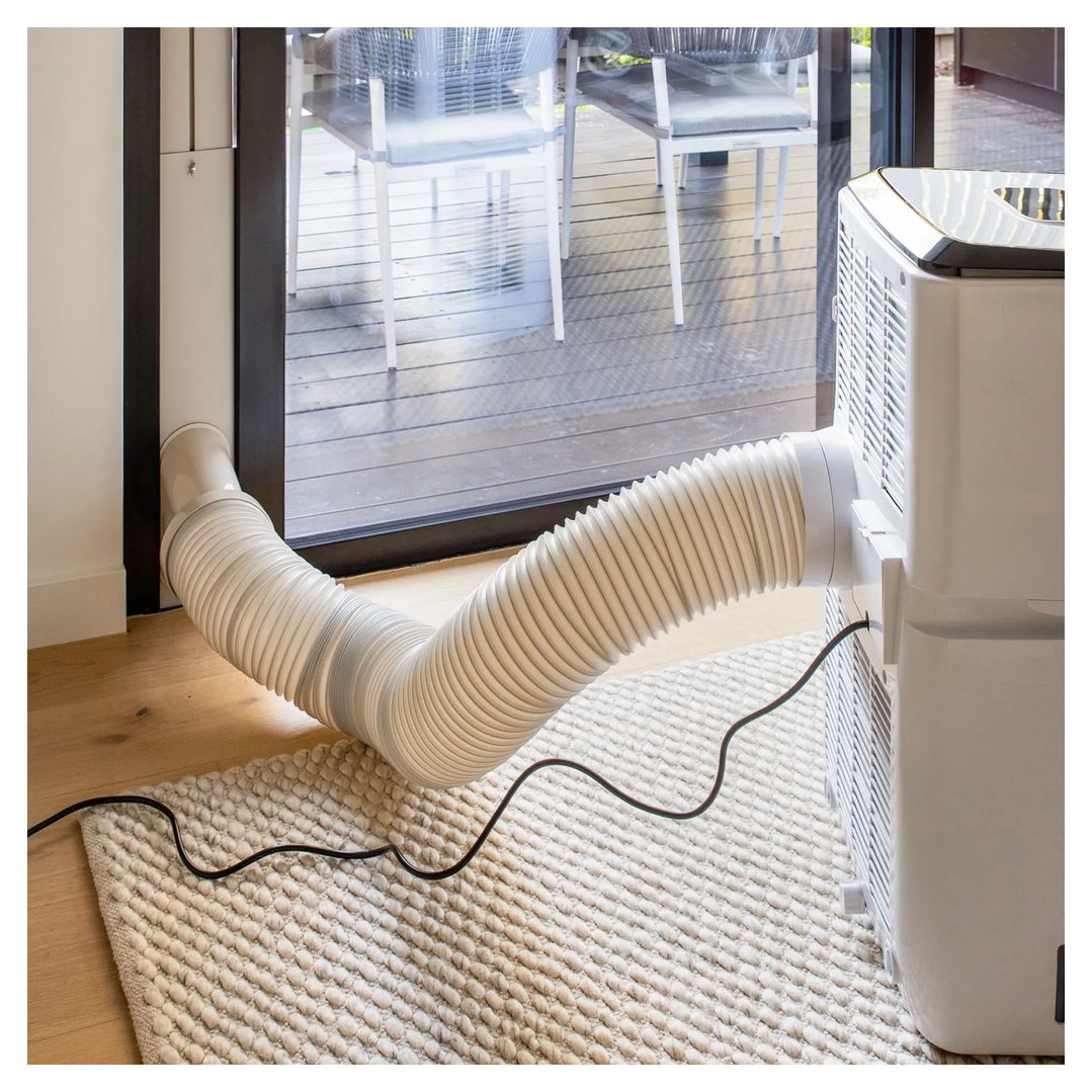 Portable air conditioner with exhaust hose connected to a glass door