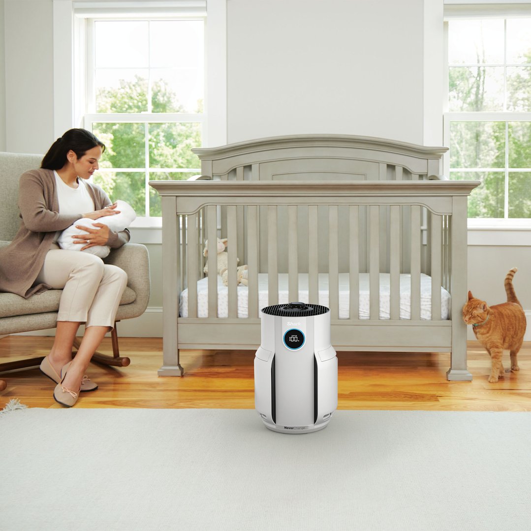 SHARK NeverChange5 Air Purifier in a nursery with a woman, baby, and cat