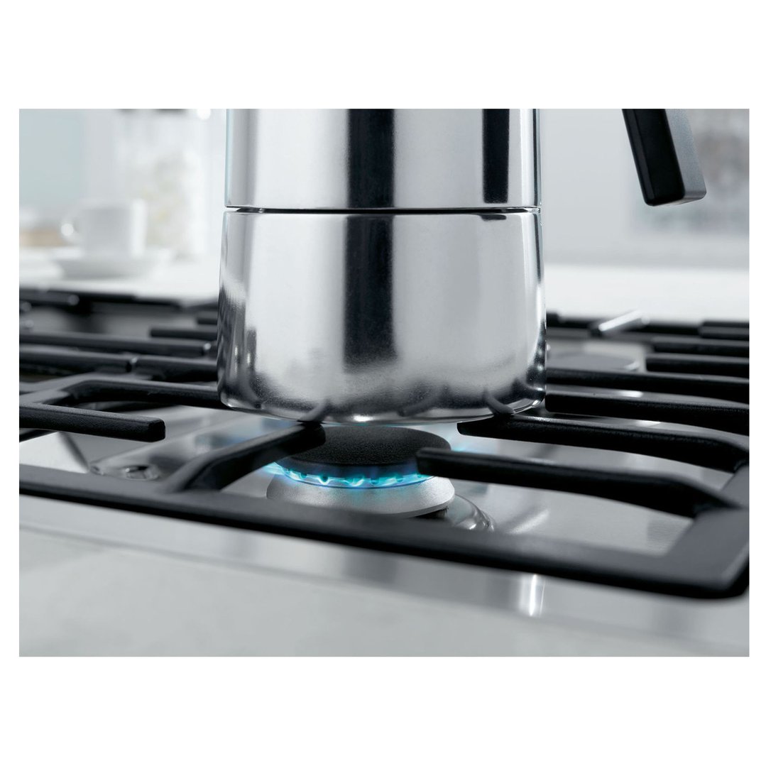 A stainless steel cooktop with a pot on a lit gas burner