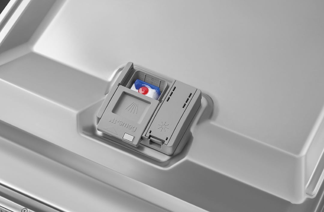 Close up of a dishwasher interior with a detergent pod in the dispenser