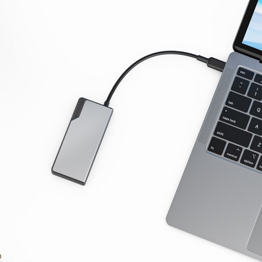 A silver USB-C Fusion CORE 5-in-1 Hub V2 connected to a laptop