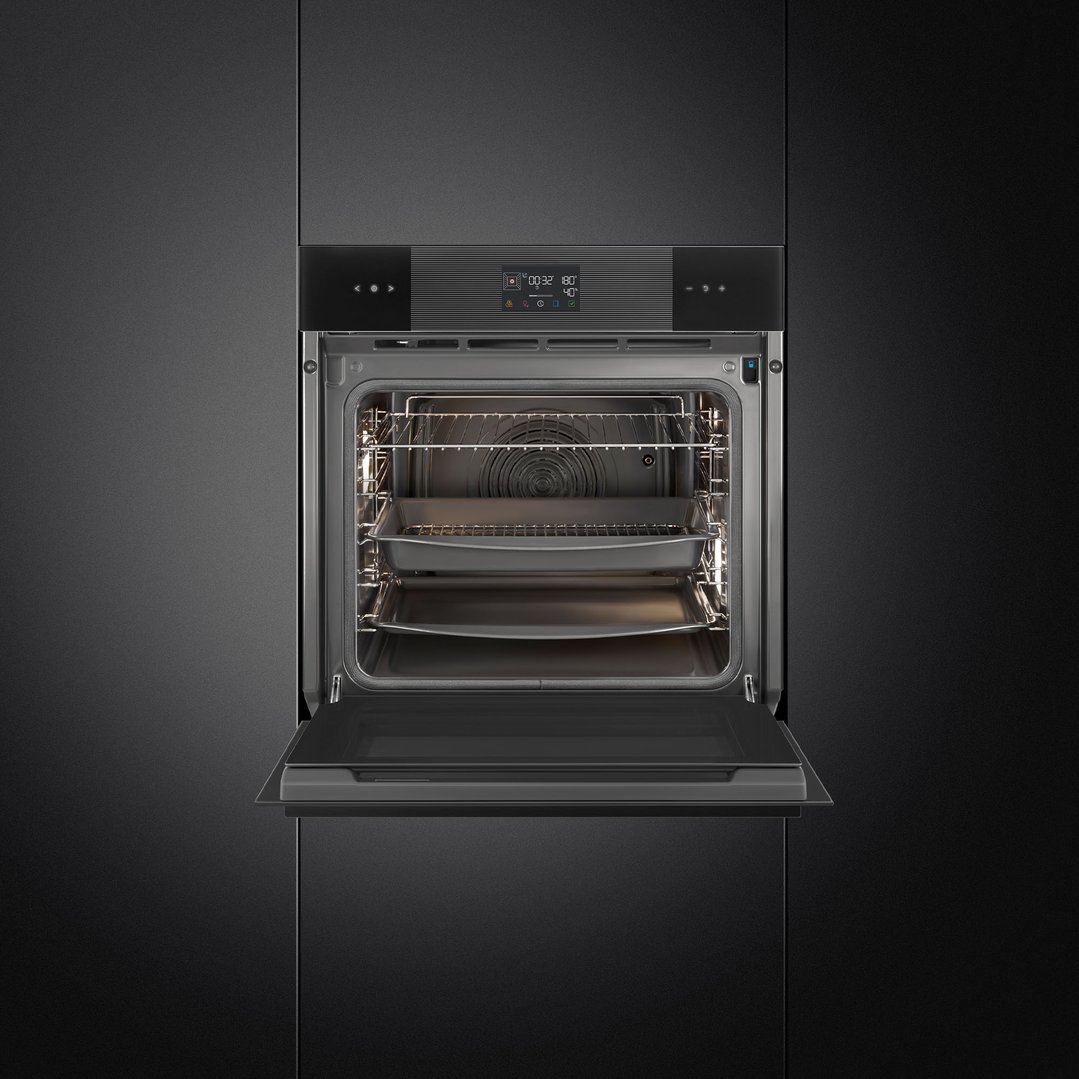 Built-in Linea oven with its door open, showing the interior racks and trays