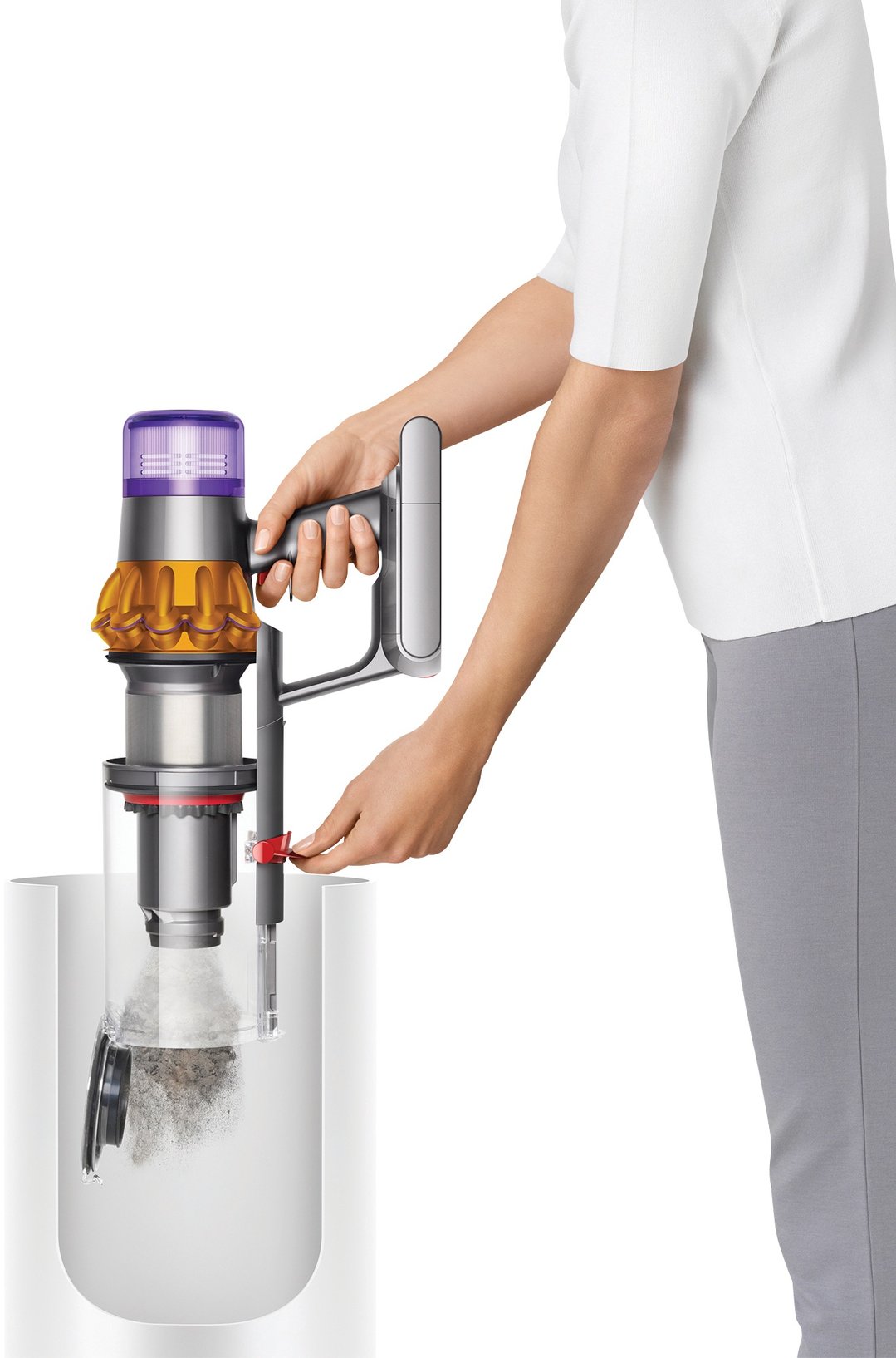 Person emptying a Dyson V15 Detect Absolute handstick vacuum into a bin
