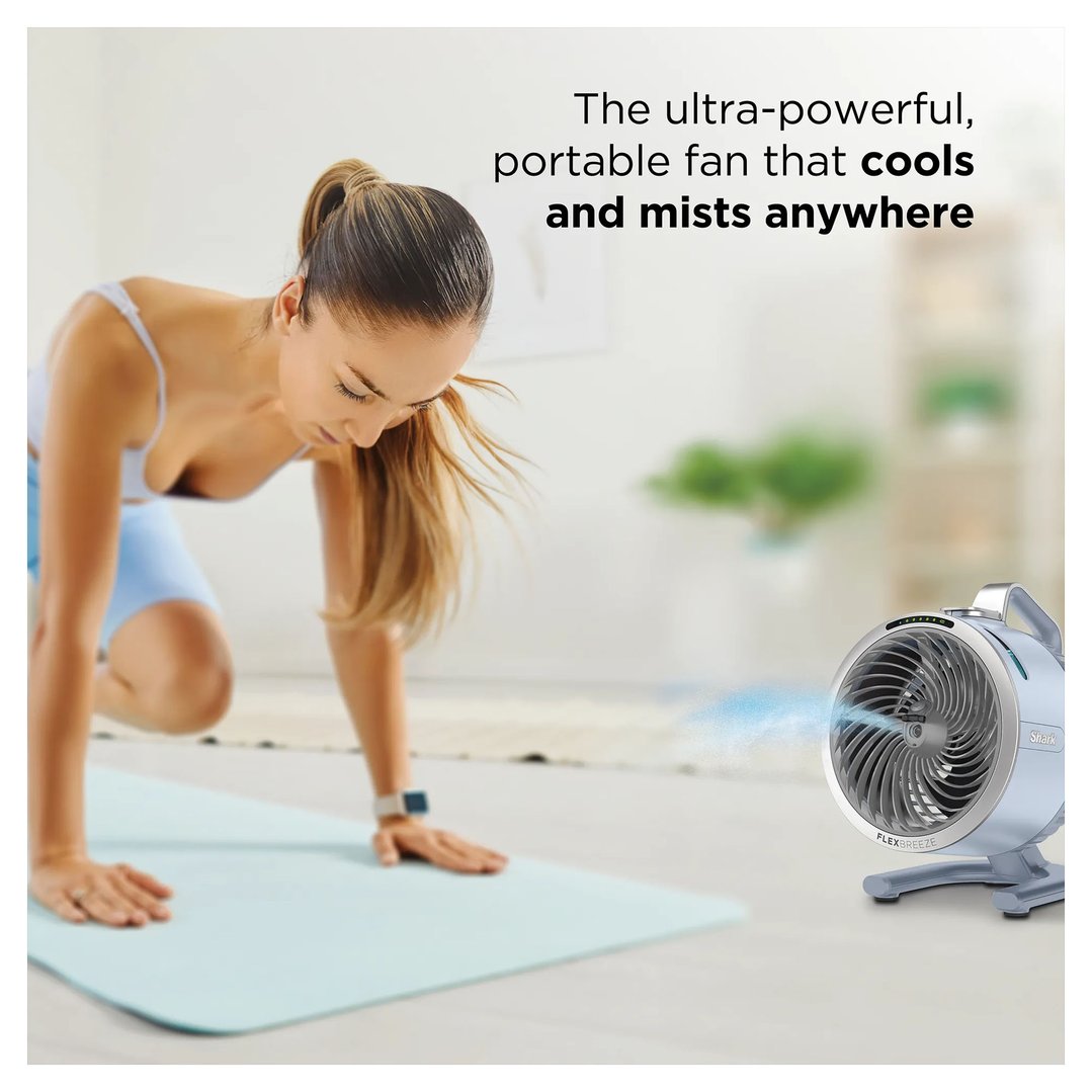 Woman exercising on a yoga mat with a Shark FlexBreeze portable fan cooling her