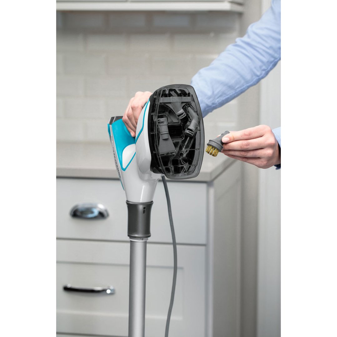 Person holding a brush attachment next to a BISSELL PowerFresh Slim Steam Mop
